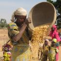 woman pouring grain out of a basket